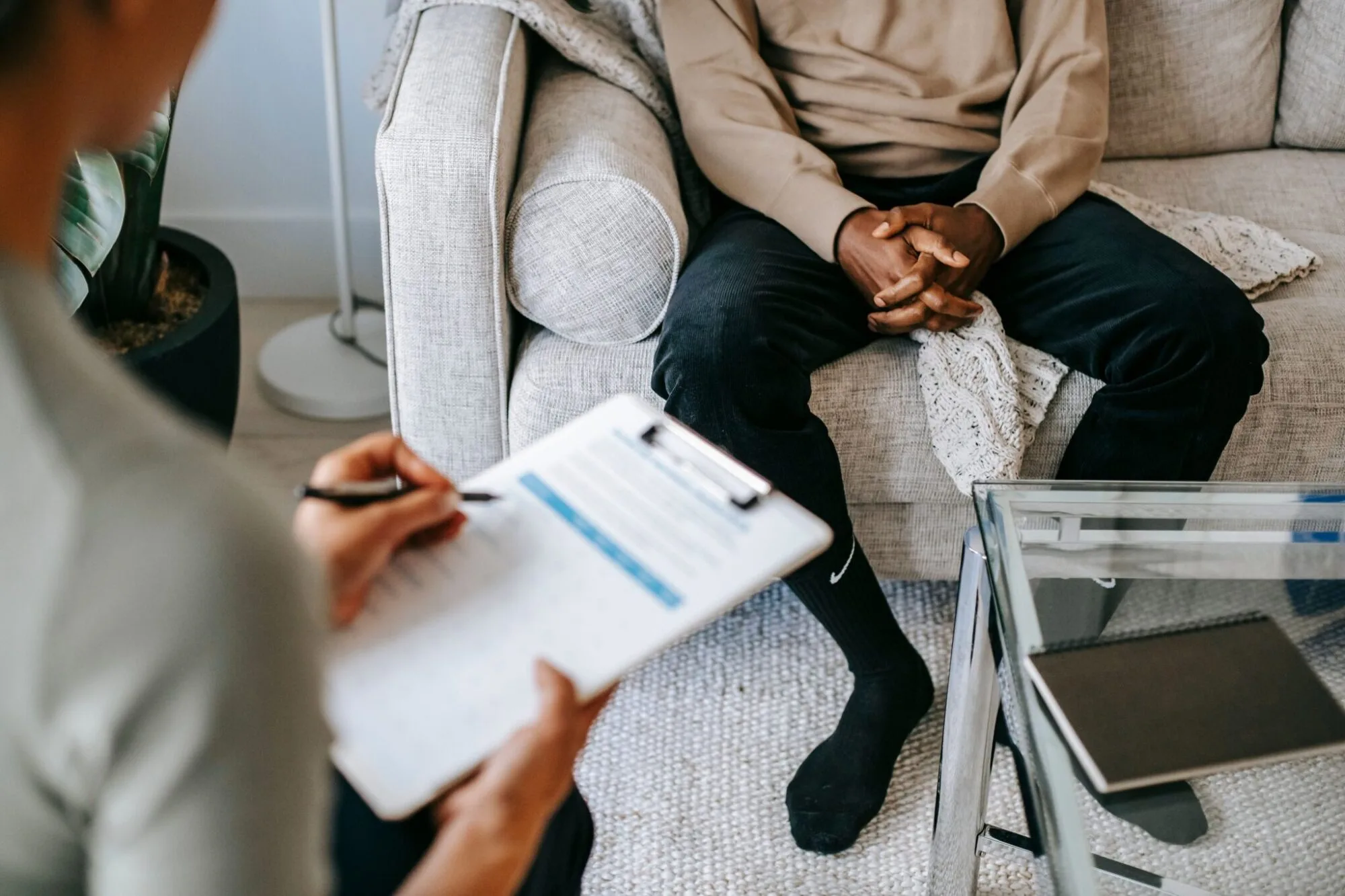 Therapist taking notes during a session with a client