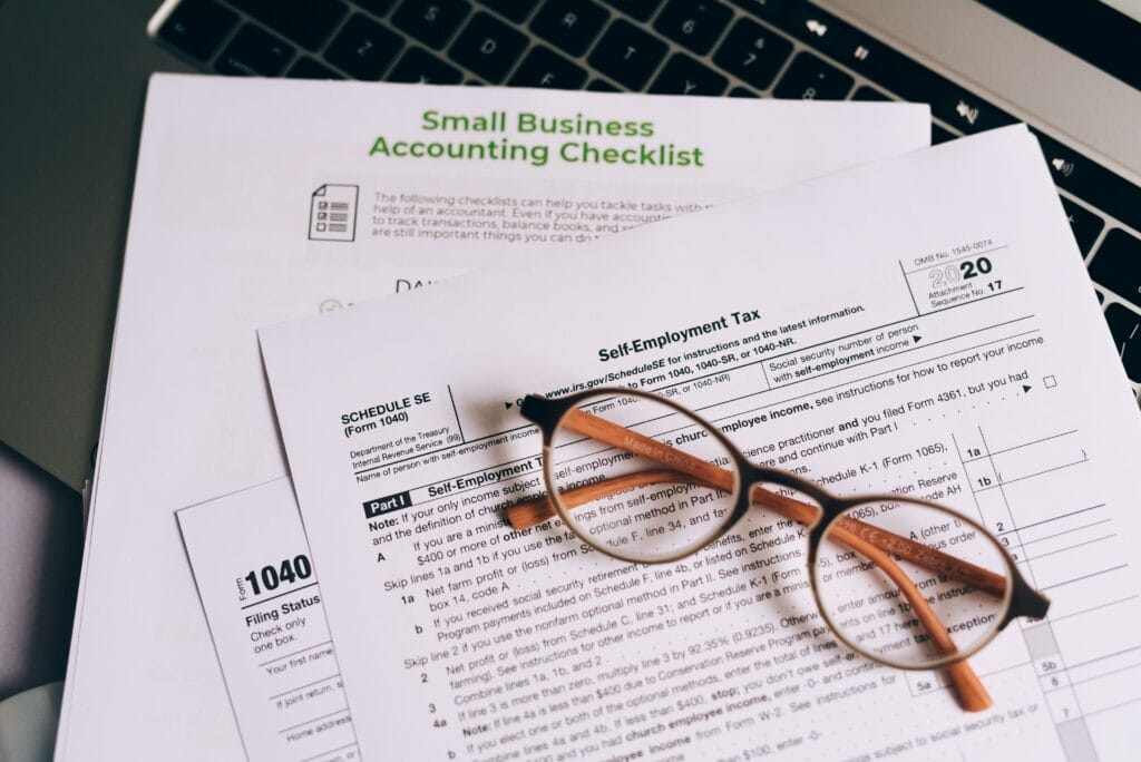 Therapist reviewing a tax deductions for therapists checklist with receipts at a desk.
